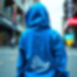 A stylish blue hoodie showcasing skateboard graphics