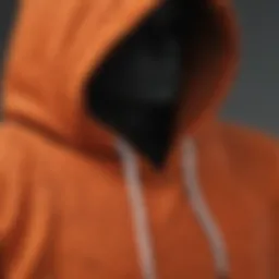 A close-up of a burnt orange hoodie showcasing its texture