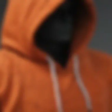 A close-up of a burnt orange hoodie showcasing its texture