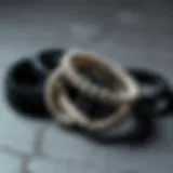 Artistic arrangement of black and white bracelets on a textured surface