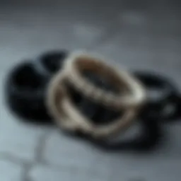 Artistic arrangement of black and white bracelets on a textured surface