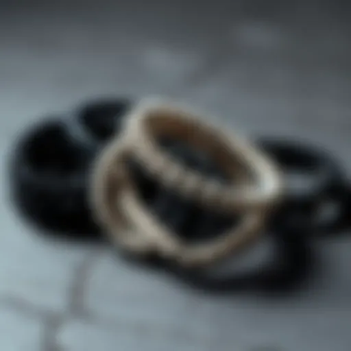 Artistic Arrangement of Black and White Bracelets Artistic arrangement of black and white bracelets on a textured surface