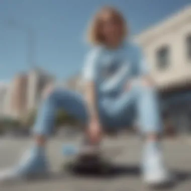 Stylish pairing of light blue ripped jeans with skate shoes and graphic tee