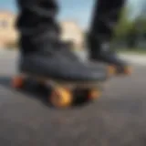 Close-up of a pair of black Vans on a skateboard deck