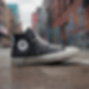 Black high top Converse sneakers against a backdrop of urban graffiti