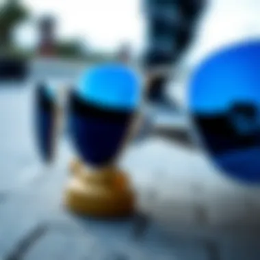 Close-up of blue reflective Ray-Bans with a skateboard in the background