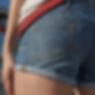 A close-up of the fabric and details of low-waisted jean shorts