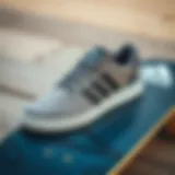 Stylish grey Adidas skate shoes on a skateboarding deck
