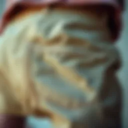 Close-up view of long chino shorts fabric and stitching