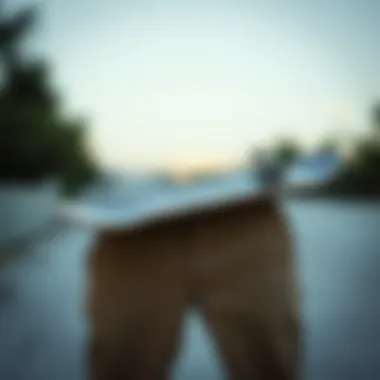 Skateboard resting on a pair of long chino shorts