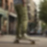 Stylish skateboarder showcasing olive green chinos in urban setting