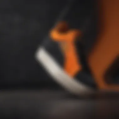 Close-up of Puma Suede Black and Orange detailing