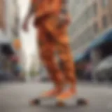 A skateboarder showcasing the vibrant appeal of orange camo pants in an urban environment.