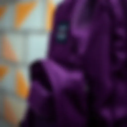 A close-up of the dark purple JanSport backpack showcasing its unique fabric texture and stitching details.
