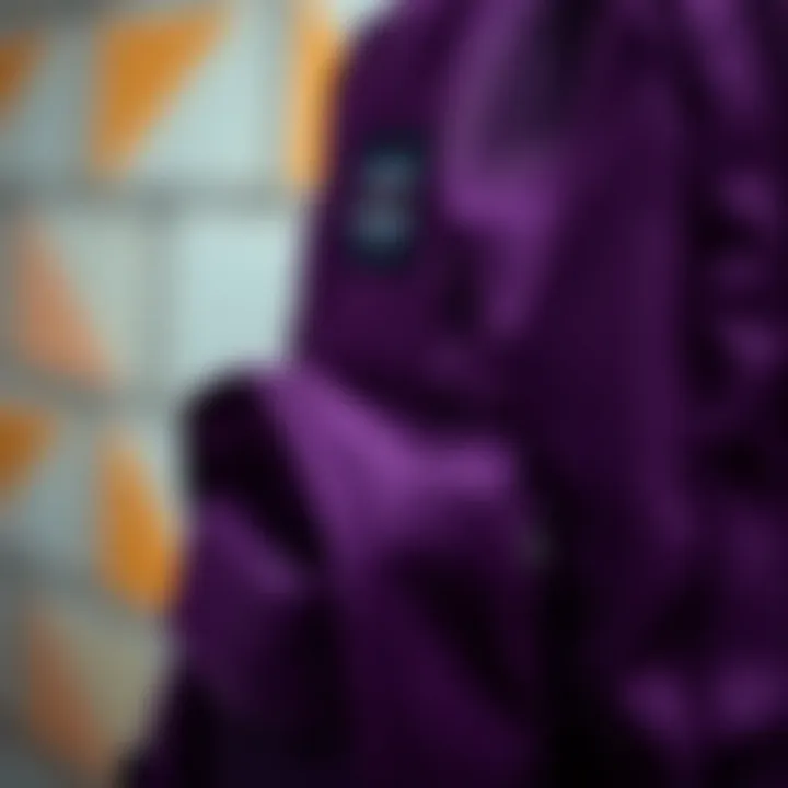 A close-up of the dark purple JanSport backpack showcasing its unique fabric texture and stitching details.
