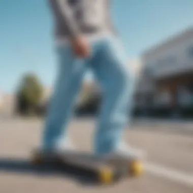 Close-up of light blue sweatpants with skateboard in the background