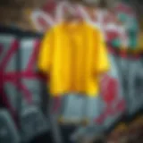 Vibrant yellow crop shirt hanging against a graffiti wall
