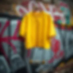 Vibrant yellow crop shirt hanging against a graffiti wall