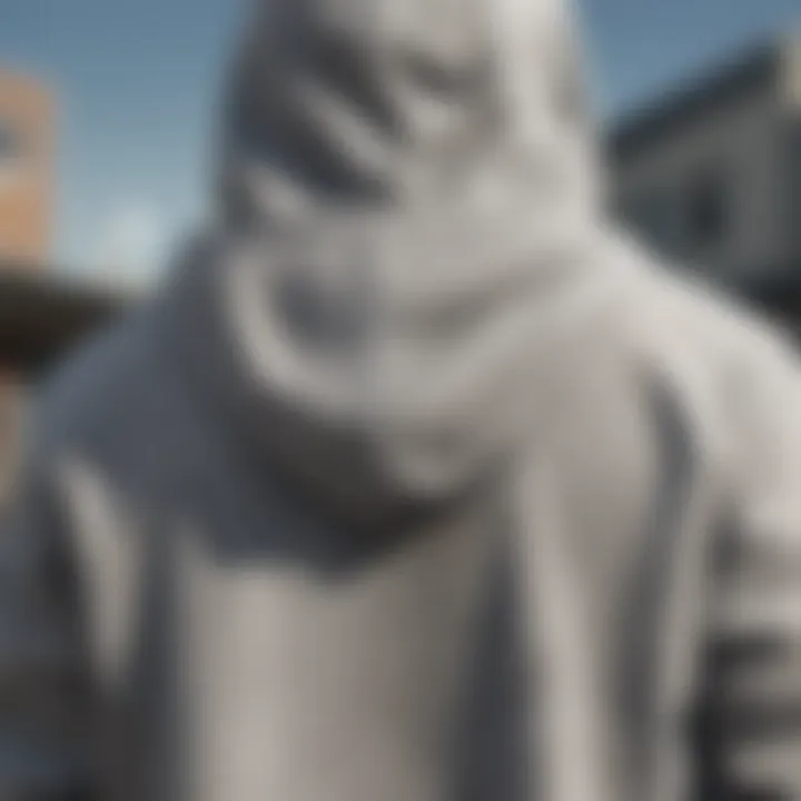 A close-up of a gray hoodie sweatshirt, highlighting its design features and textures.