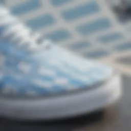 A close-up view of light blue and white checkered Vans on a skateboard