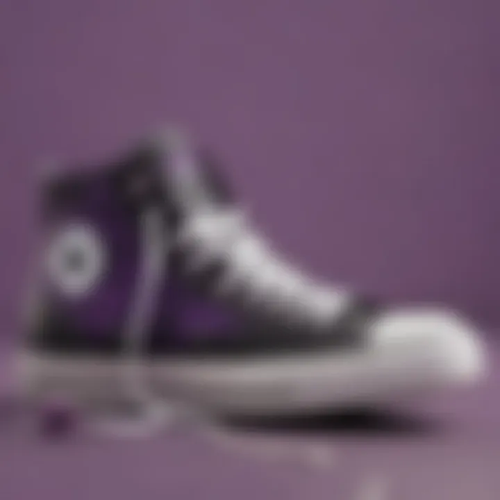 Close-up of black and purple Converse high tops on a skateboard