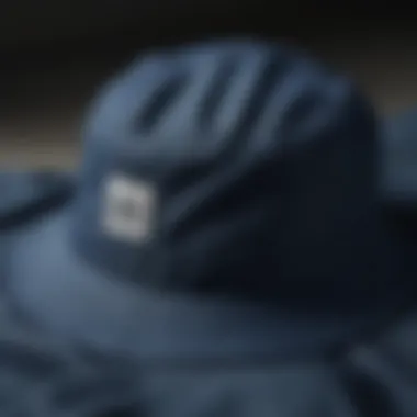 Close-up view highlighting the fabric texture of the dark blue bucket hat.