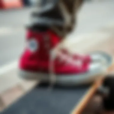 A pair of maroon Chuck Taylor Converse sneakers on a skateboard