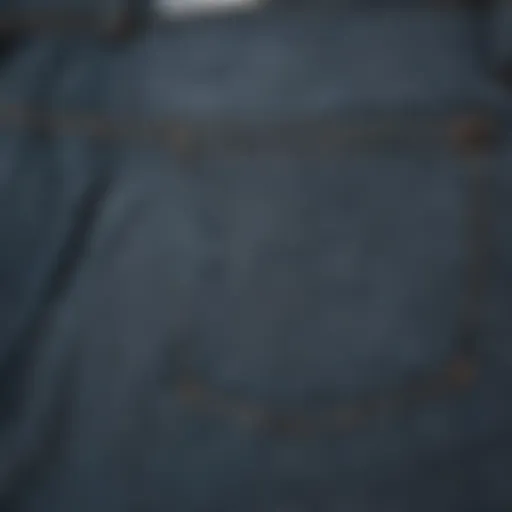 Close-up view of Topman mid wash slim tapered jeans showcasing the fabric texture and detailing.